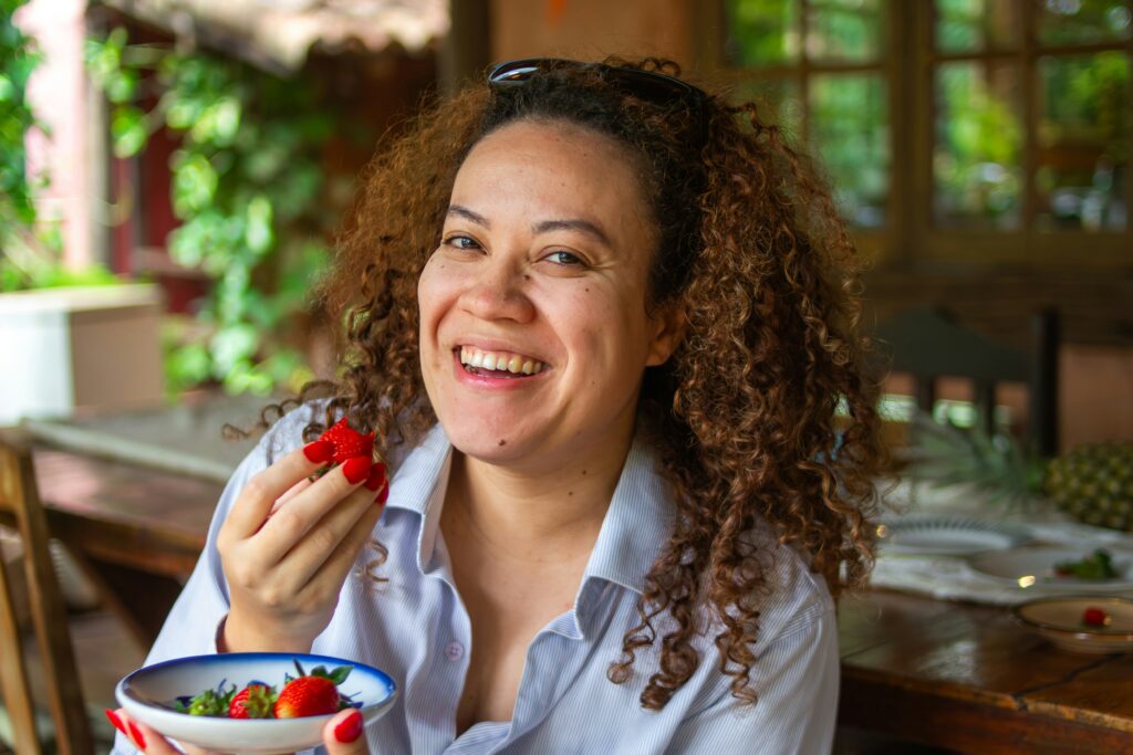 woman eating fruit strawberry healthy eating on vacation