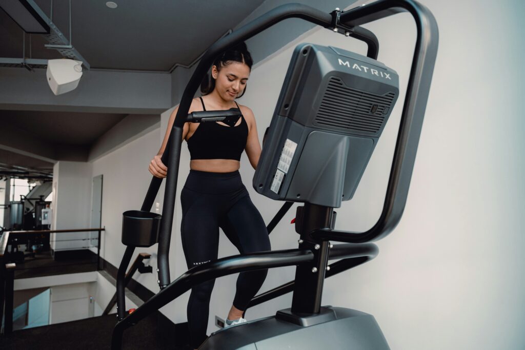 woman at the gym on the elliptical