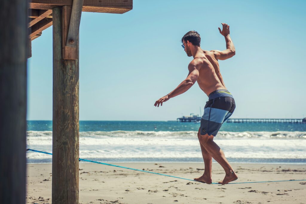 man exercising on the beach working out how to exercise in summer heat