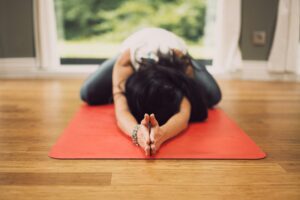 what is hot yoga - woman doing yoga on yoga mat