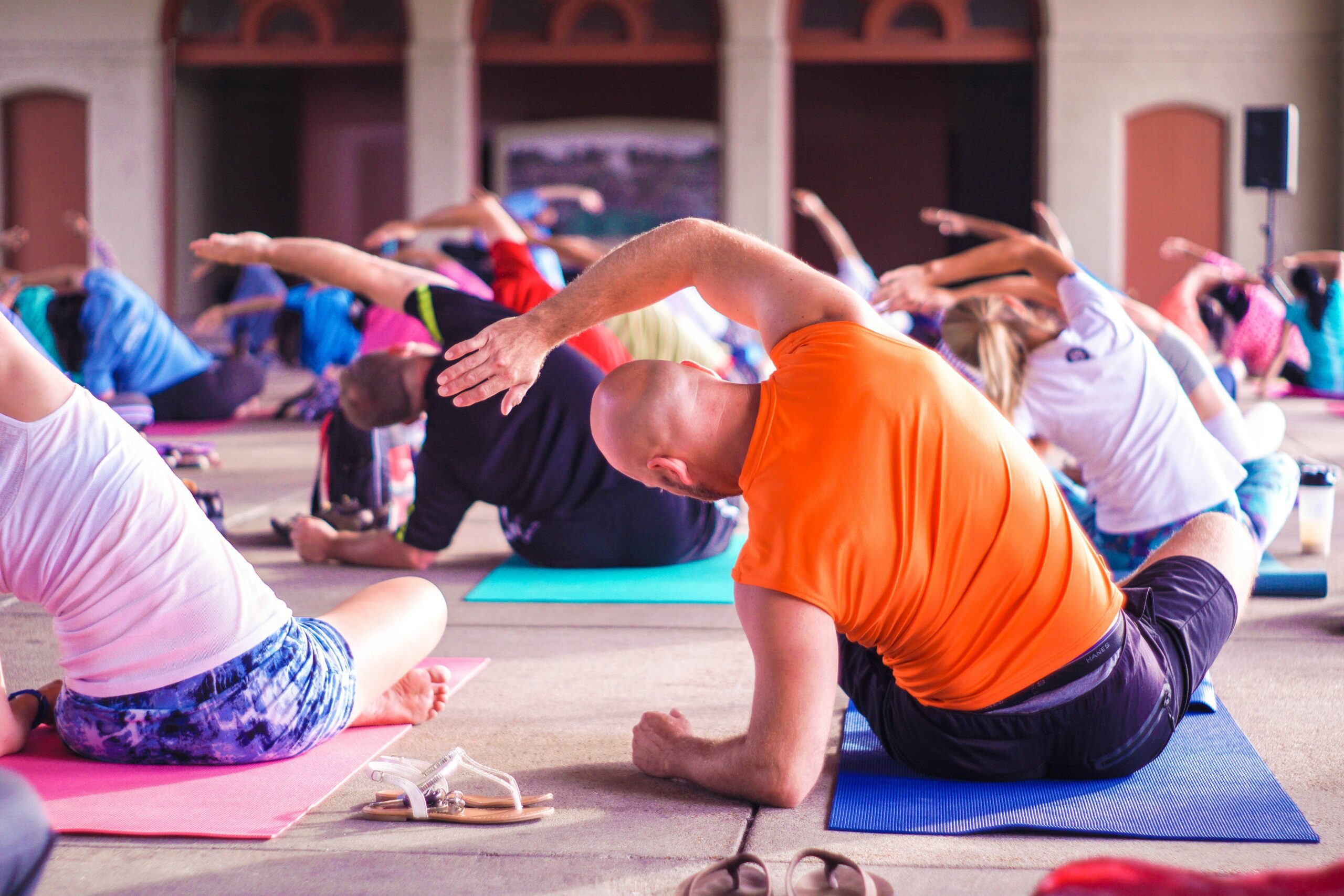 man doing yoga weekly workout schedule stretching