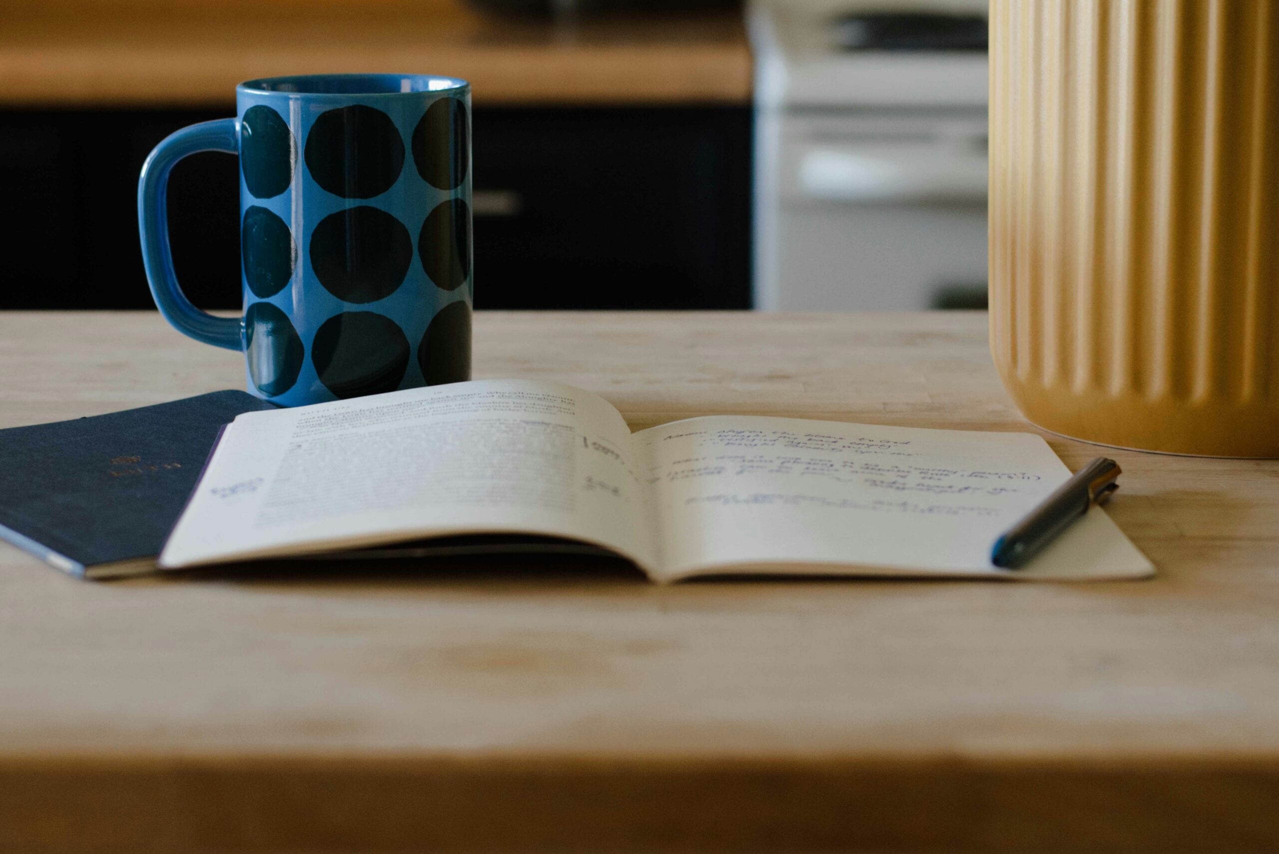 reflection notebook and mug on desk self improvement habits