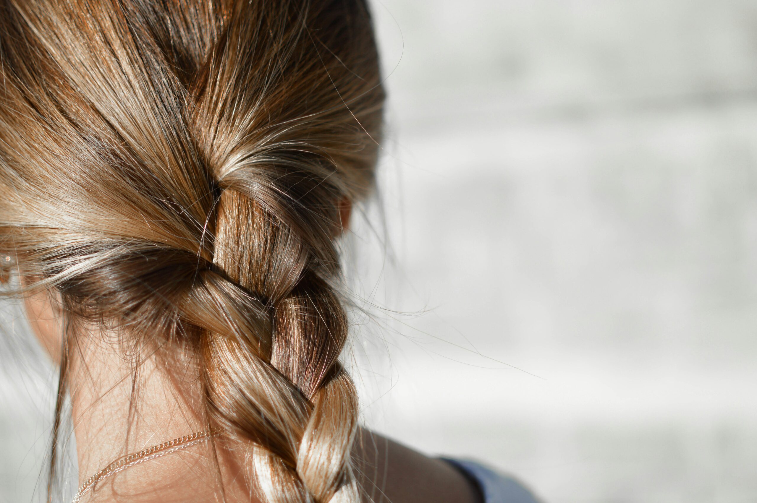 woman with hair in braid vitamins for hair growth