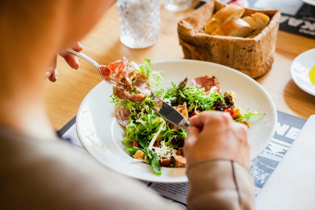 person eating a salad healthy eating on vacation