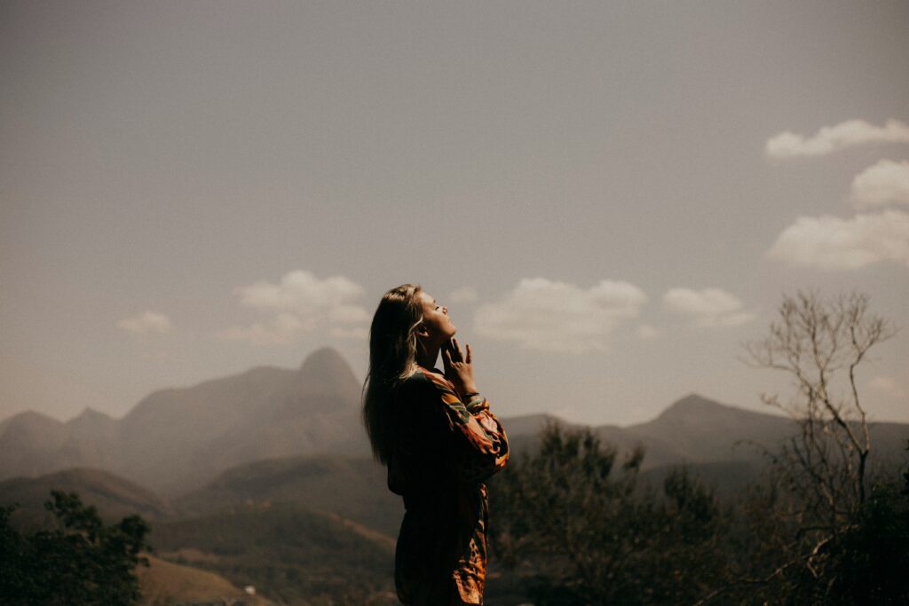 woman praying meditating outside emotional exhaustion signs