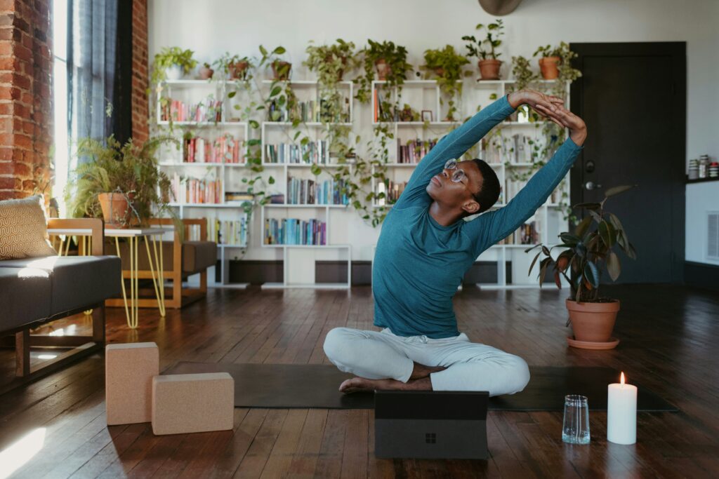 man doing yoga exercise at home wellness stretrching