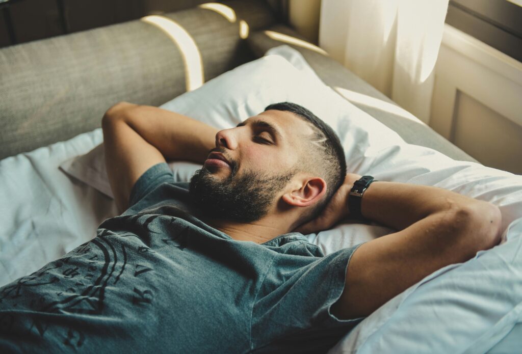 man taking a nap sleeping tired exhaustion fatigue labor day wellness rituals