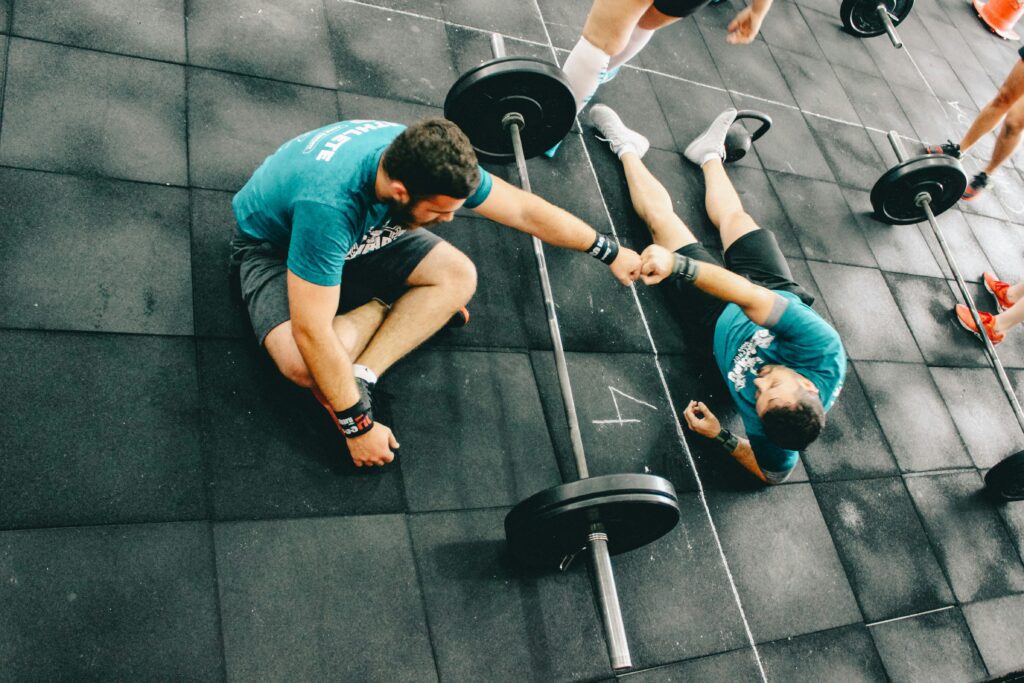 man at gym with friend lifting weights fall fitness reset