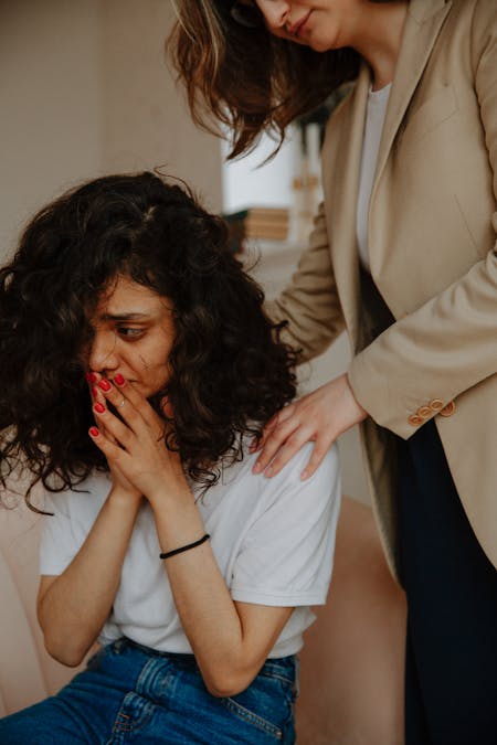 woman comforting other woman mental health and the holidays