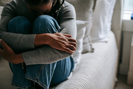mental health statistics person hugging their knees