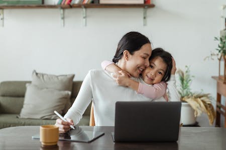 balanced life - mom with daughter in front of laptop