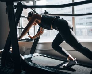 woman working out at gym - how to break fitness plateaus