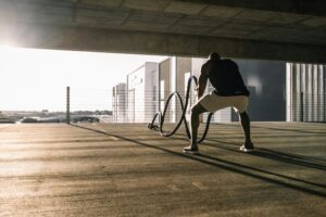 how to break fitness plateaus - man doing workout ropes