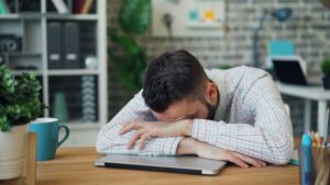 tired man at his desk - chronic fatigue solutions