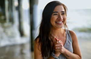 woman smiling at beach - Toxic Positivity