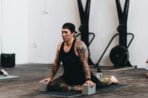 man stretching at gym - What happens if you don't stretch after a workout