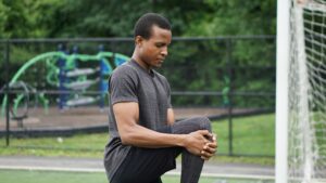 guy stretching before run - What happens if you don't stretch after a workout