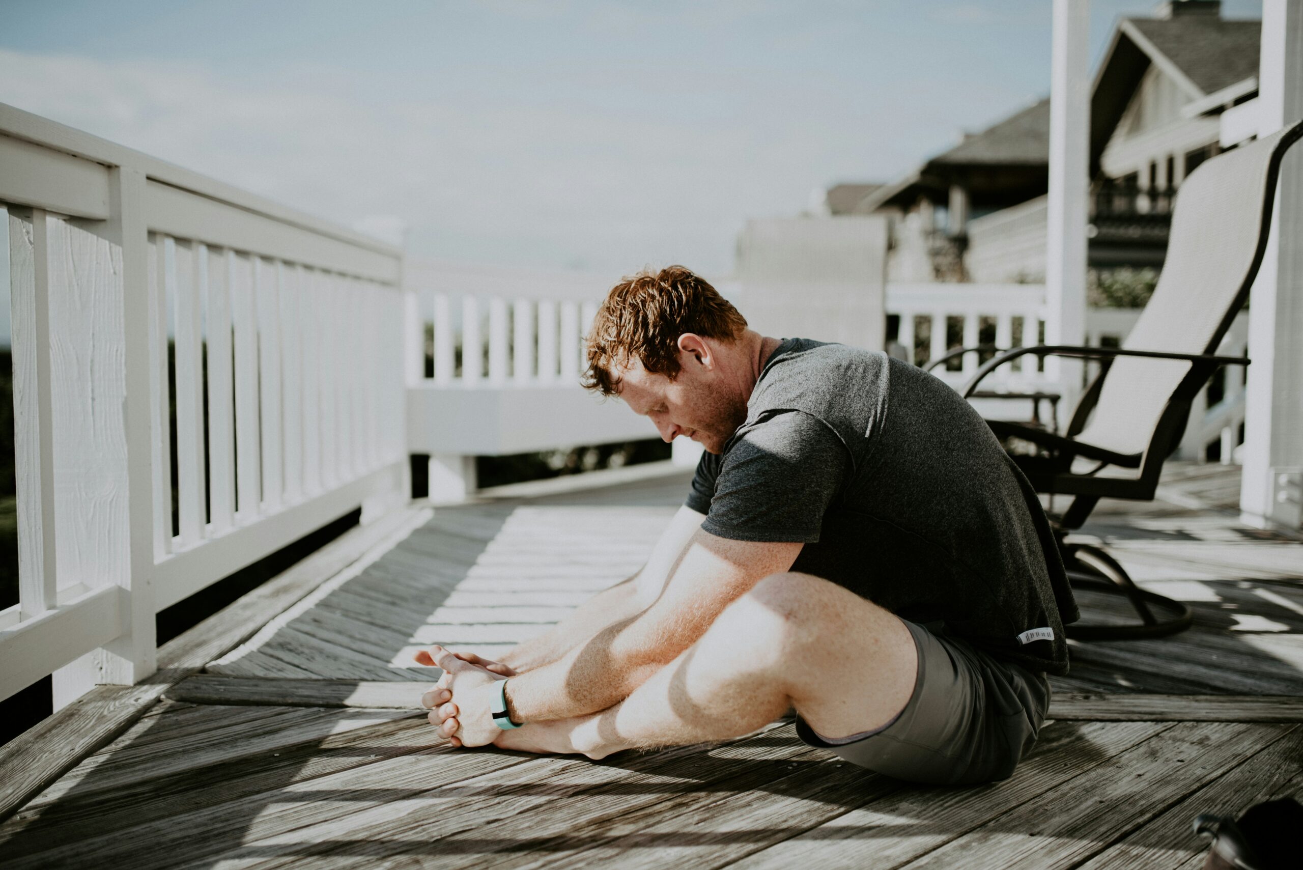 routine for better energy What happens if you don't stretch after a workout - man doing yoga stretches how to calm the sunday scaries