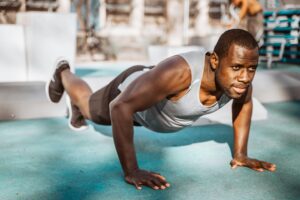 man doing push ups mountain climbers - endurance exercises