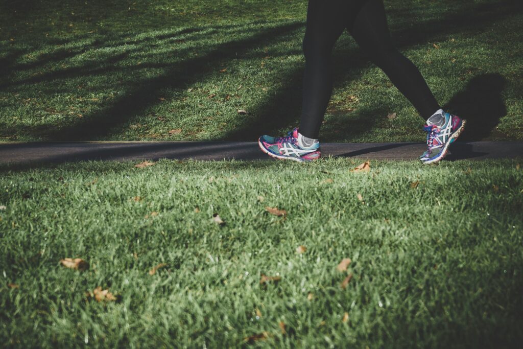 person walking outdoors running shoes