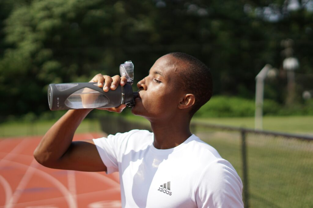 man drinking water how to stay hydrated in summer