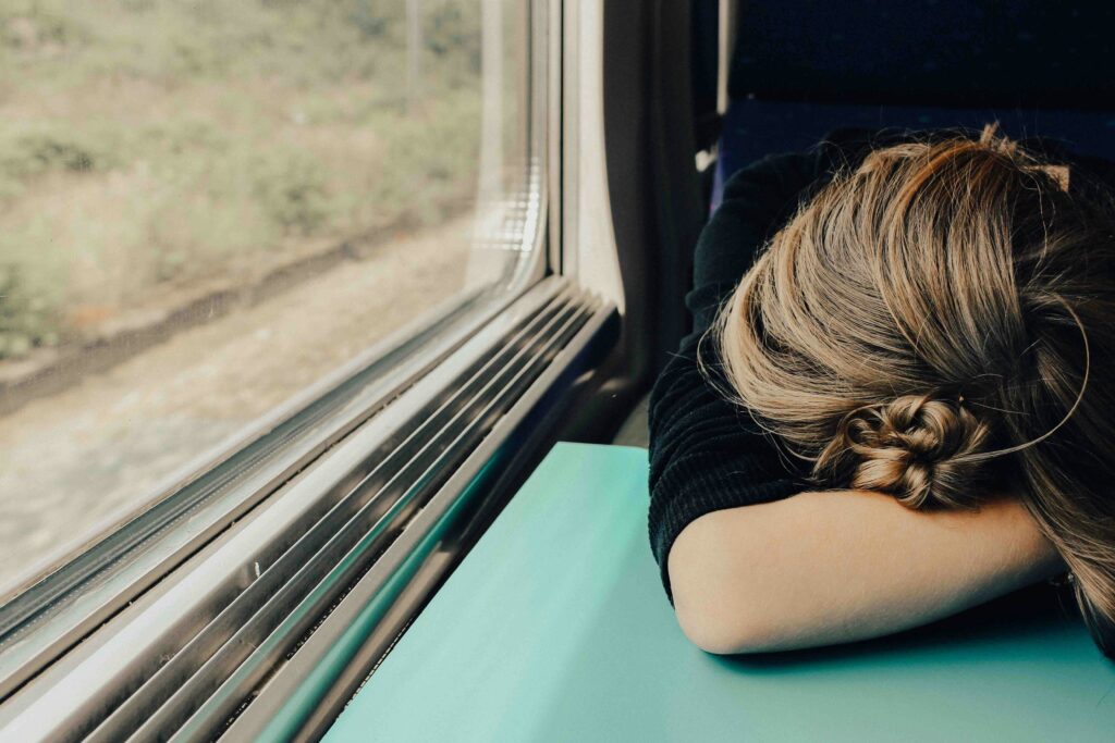 signs of burnout woman sleeping on a train