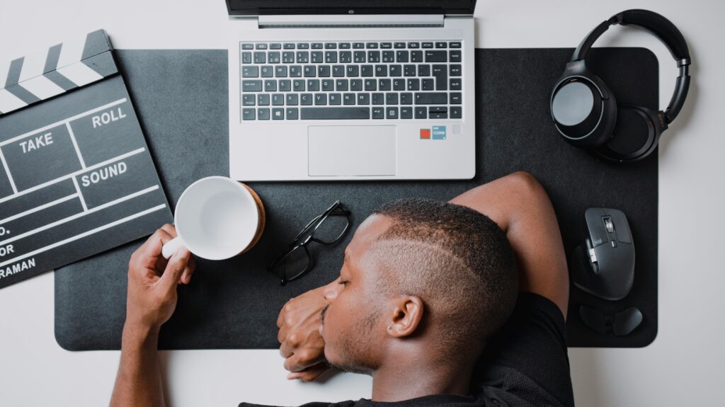 signs of burnout man sleeping at desk while working